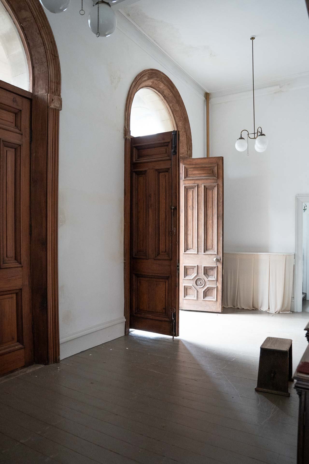 The entrance hall to Green Street Chapel with the double doors open with light streaming in